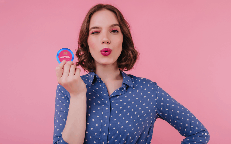 Girl is holding lip tint in her hands 