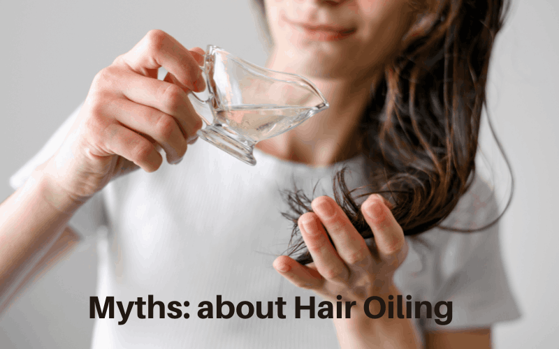 Girl is pouring oil from glass cup on her hairs 