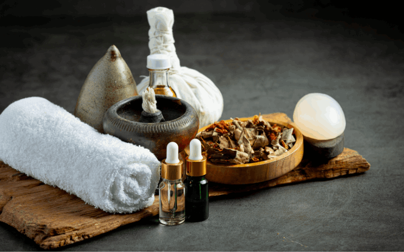 body oil and other things like towel ,ayurvedic herbs are placed on cloth